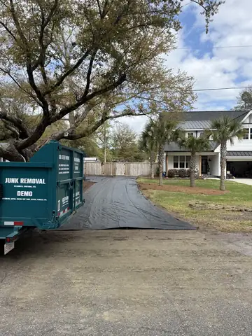 Geotextile fabric rolled out on a new driveway beside the Southern Hauling dump trailer