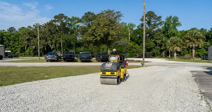 Roller compacting a new gravel parking lot