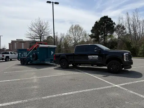 Southern Hauling and Clearing pickup towing the dump trailer with the Kubota track loader aboard