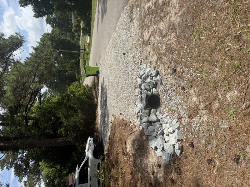 Gravel driveway installed with a new culvert pipe at the road ditch