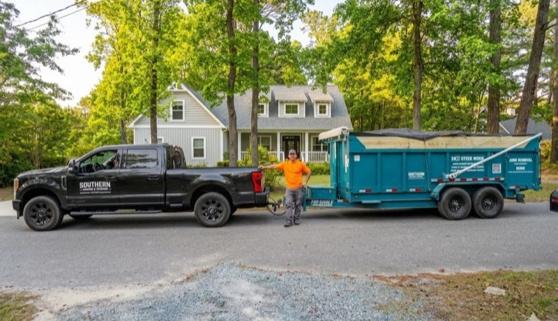 Ryan with the Southern Hauling and Clearing truck and dump trailer in Wilmington, NC