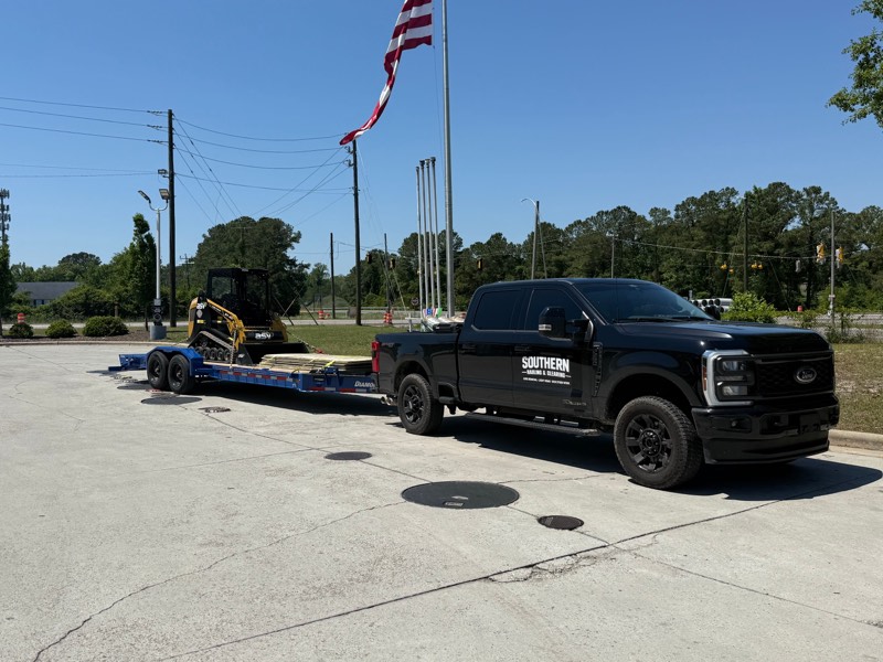 Southern Hauling & Clearing truck and dump trailer with Kubota track loader