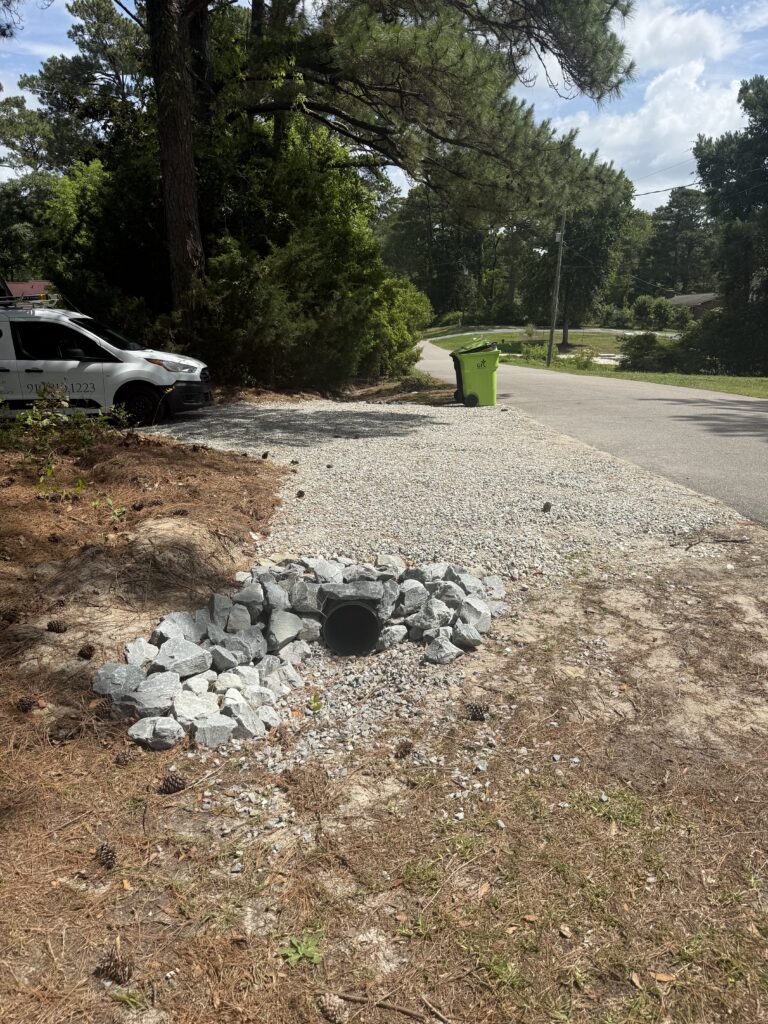 Gravel driveway installed with a new culvert pipe at the road ditch